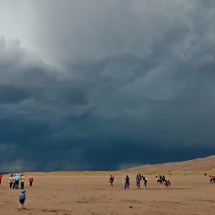 Crowded Great Sand Dunes National Park with black clouds - thunder and lightning are coming!